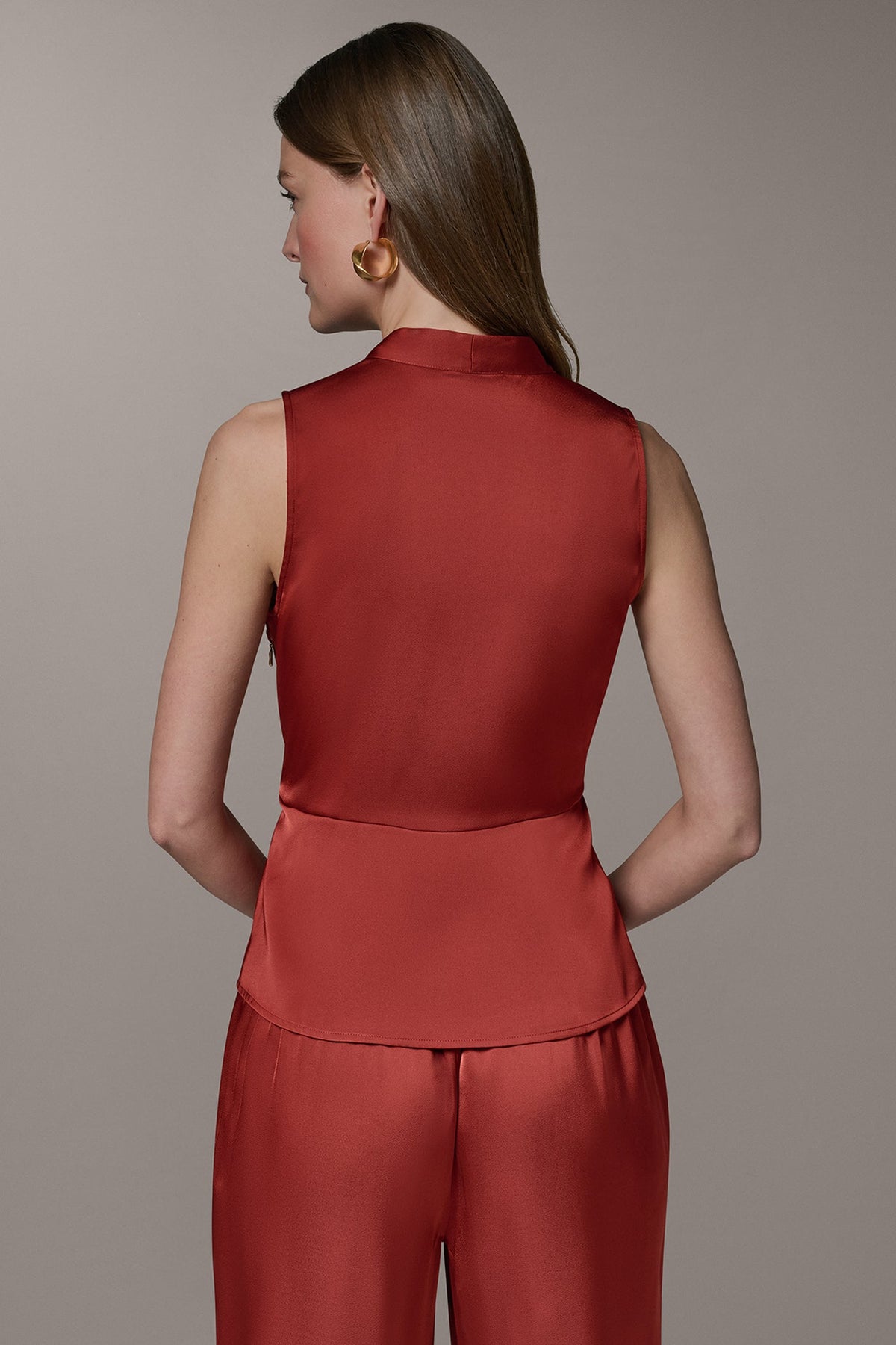 SLEEVELESS WRAP-EFFECT ASYMMETRIC PEPLUM BLOUSE